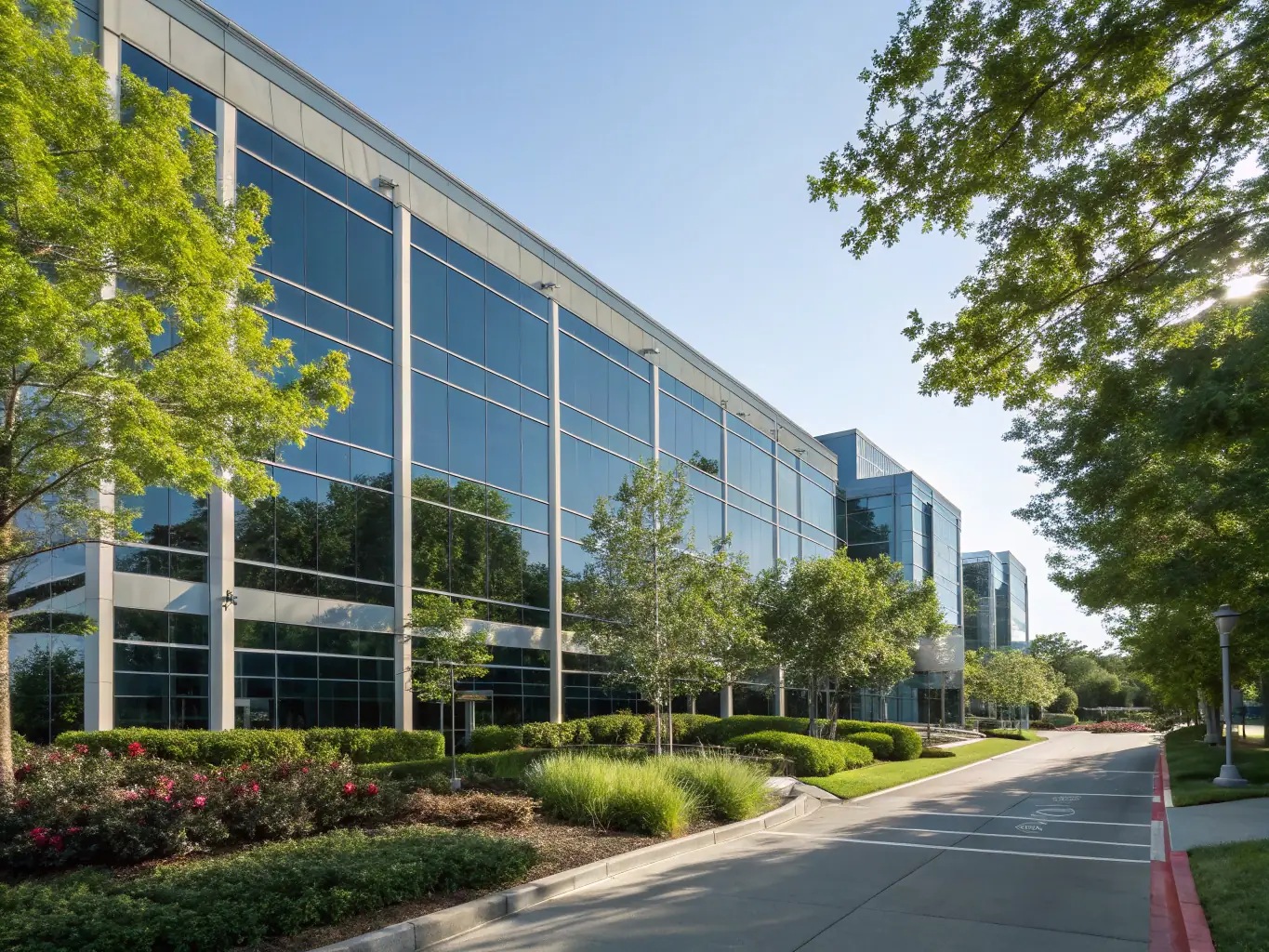 A modern office building exterior with multiple floors and large windows, representing multi-location organizations and the need for seamless connectivity between different branches, showcasing DataTel 360's multi-location solutions.