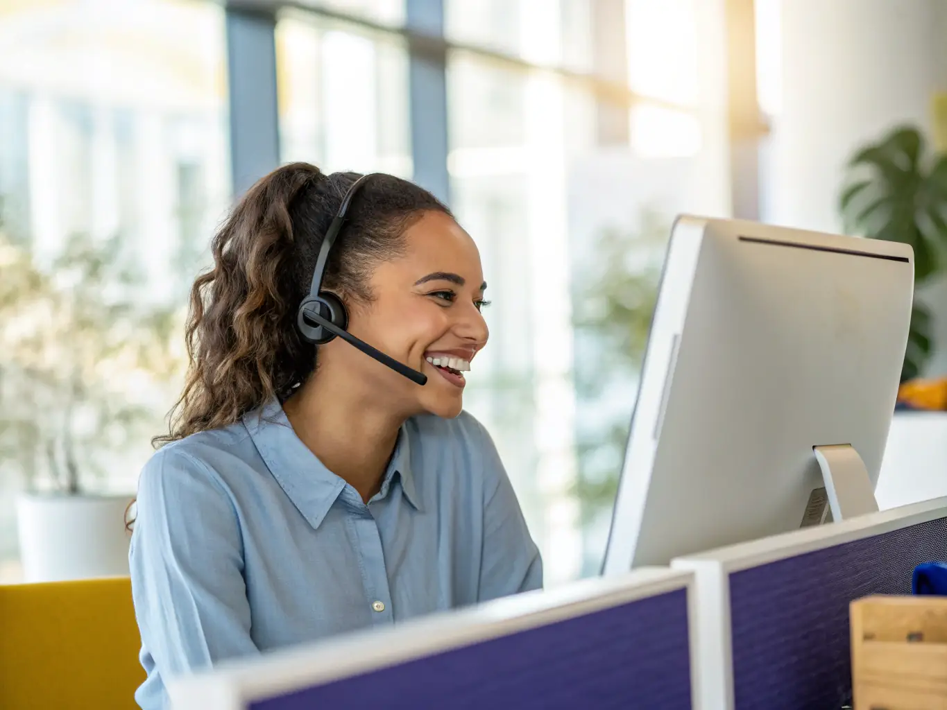 A friendly customer service representative assisting a client over the phone, emphasizing DataTel 360's commitment to customer satisfaction.