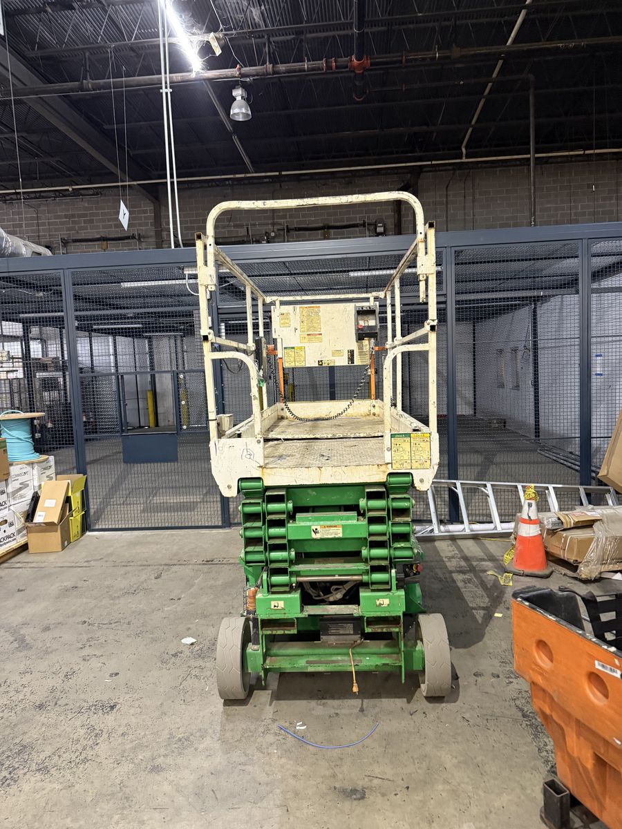 Aerial lift positioned for overhead Cat 6 cabling installation in a warehouse by DataTel 360